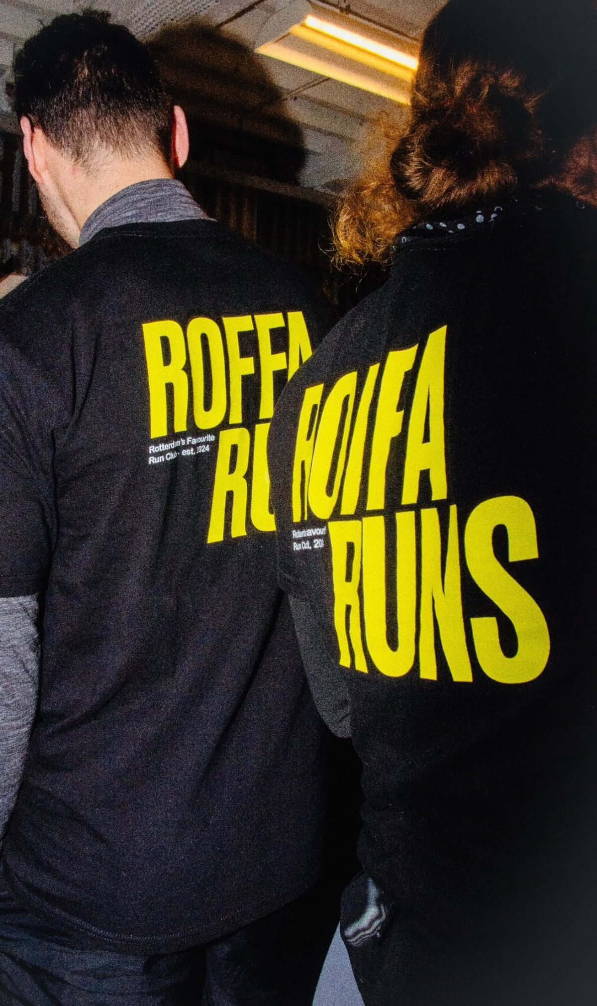 Two runners in Roffa Runs shirts from behind